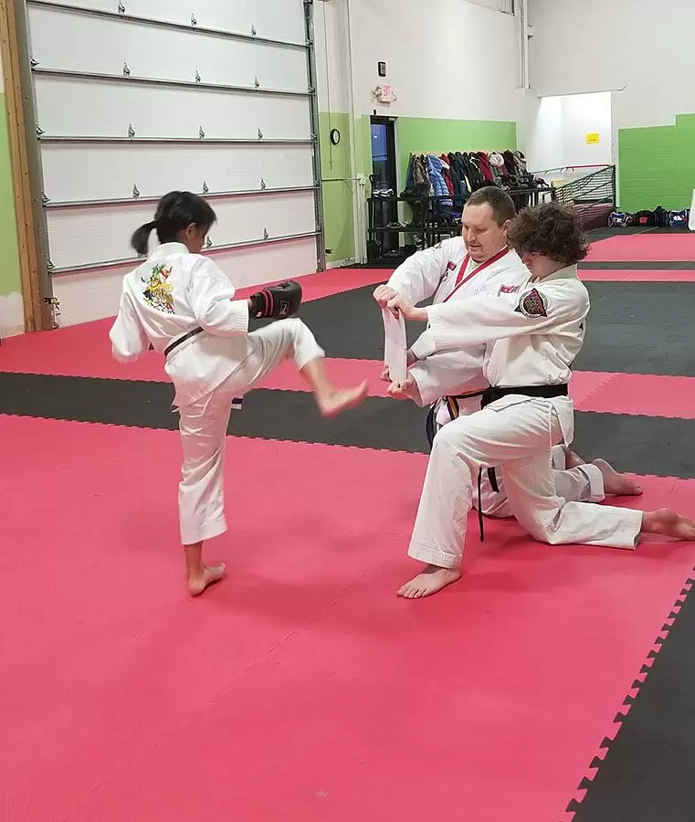 4Kicks Family Taekwondo kid breaking board